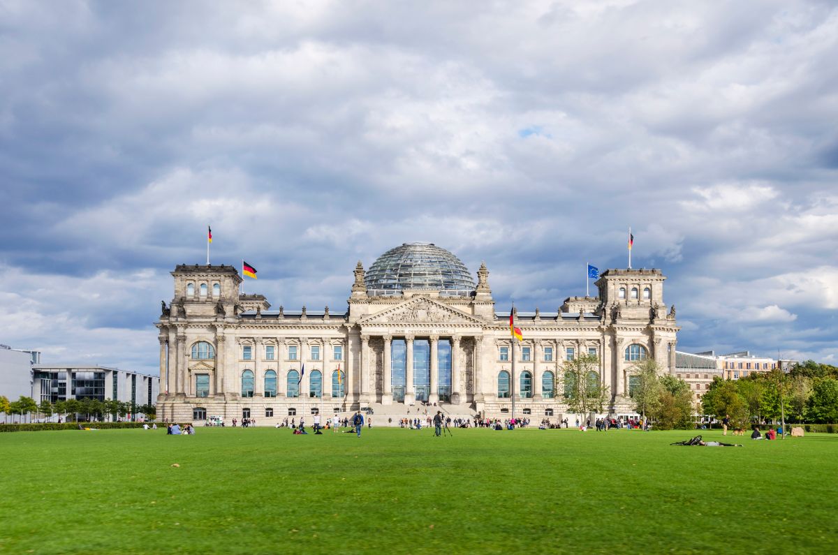 Bundestagsgebäude in der Frontalansicht mit dunklen Wolken im Hintergrund